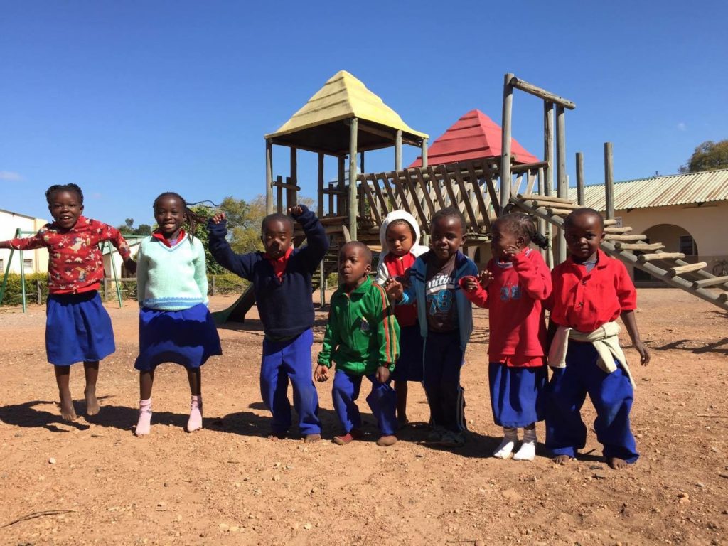 Kafakumba children standing in front of playground